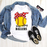 Busy Raising Ballers Softball Sublimation Transfer, a white t-shirt with a yellow softball graphic and a red polka dot bow, laid out with a denim jacket, sunglasses, and black Vans shoes.