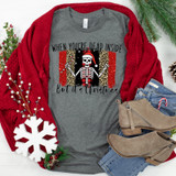 Dead Inside But It's Christmas Brushstrokes Screen Print Heat Transfer T-shirt, featuring a skeleton wearing a Santa hat with a festive background, holiday decorations, and a red cardigan.