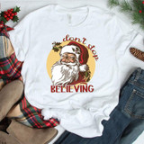 Don't Stop Believing Santa Sublimation Transfer - Festive Christmas t-shirt featuring Santa Claus with holiday design and text.