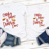 Chunky Thighs & Pumpkin Pies Sublimation Transfer, white T-shirts with pumpkin and pie graphics and playful red text, laid flat on a wooden surface with denim jeans and sneakers.