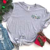 Peace On Earth HAT/POCKET Screen Print Heat Transfer, light gray T-shirt with festive design featuring the text 'Peace On Earth' and a hanging ornament, surrounded by Christmas decorations.