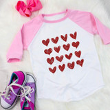 Red Hearts Metallic YOUTH Screen Print Transfer, pink and white raglan shirt with a pattern of red metallic hearts on it.