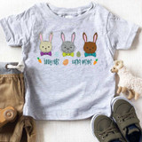Bunny Hugs Easter Wishes Youth Screen Print Heat Transfer, a children's t-shirt featuring three cute bunny faces with colorful bow ties, Easter eggs, and carrots on a light grey background.