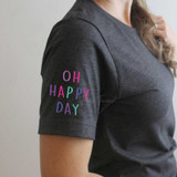 Oh Happy Day POCKET/MASK Screen Print Heat Transfer, colorful lettering on the sleeve of a dark gray shirt.