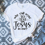 Why Y'all Tryin' To Sublimation Transfer, white T-shirt with black printed text 'Why Y'all Tryin' To Test The Jesus in Me?' displayed on a patterned fabric background.