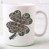 Lace 4 Leaf Clover Sublimation Transfer, ornamental black lace design with green outline on a white ceramic mug.