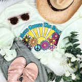 Here Comes The Sun Screen Print Heat Transfer, colorful sun, flowers, peace symbols, and text design on a white shirt.