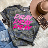 Stacked Pray Pink Screen Print Transfer, casual camouflage sweatshirt with pink text saying 'Pray and Pray over it through it' surrounded by accessories including a wide-brim hat, striped socks with embellishments, ripped jeans, and a belt with a decorative buckle.