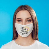 Eat Sleep Softball Repeat Sublimation Transfer, a white face mask with black text and yellow and red softball design on a woman with brown hair and blue eyes against a blue background.
