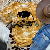 Black Sheep Screen Print Heat Transfer on a yellow tie-dye t-shirt, black sheep graphic with the text 'Black Sheep Anonymous', showcased with accessories and denim jeans.