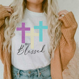 Truly Blessed Sublimation Transfer, colorful cross design on white t-shirt with the words 'Truly Blessed' in stylish font.