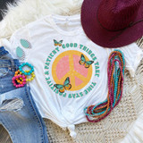 Good Things Take Time Sublimation Transfer, colorful peace sign t-shirt with butterfly graphics, paired with denim shorts, vibrant jewelry, and a wide-brimmed red hat, all laid out on a textured surface.