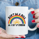 Don't Be A Dick Sublimation Transfer, white ceramic mug with rainbow and sun design and humorous motivational message.
