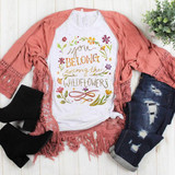 You Belong Among The Wildflowers Sublimation Transfer, T-shirt with floral design and inspirational quote on a flat lay display.