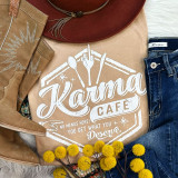 Karma Cafe Screen Print Heat Transfer, a beige t-shirt with a white graphic of cutlery and the text 'Karma Cafe' and 'No Menus Here! You Get What You Deserve'.