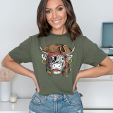 Shaggy Cow Pirate Screen Print Heat Transfer, image of a woman wearing a green t-shirt with a pirate cow design featuring a cow head with pirate accessories and a hat.