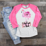 I Don't Give A Flock Flamingo Watercolor Art Sublimation Transfer, pink flamingo with flower design on a white and pink raglan shirt, paired with distressed jeans.