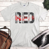 Remember Everyone Deployed Sublimation Transfer on a white T-shirt, featuring a distressed design with black and red text.