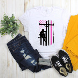 Lineman Pink Line Flag Sublimation Transfer, white T-shirt with a graphic design of a lineman on a pole in black with pink and black stripes and pink stars in the background.