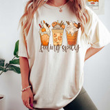Feeling Spicy DTF Heat Transfer, illustrated graphic of three whipped cream-topped fall-themed drinks with pumpkins and cinnamon sticks, with 'feeling spicy' text below on a t-shirt.