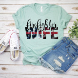 Fire Fighter Wife Red Line Screen Print Heat Transfer T-shirt, with an American flag design and bold lettered words 'firefighter' and 'WIFE' on a pastel green background.