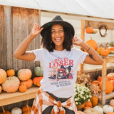 We're Going Witchin' Screen Print Heat Transfer, woman wearing Halloween-themed graphic t-shirt with pumpkins in the background.