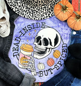 Dead Inside But Spiced Screen Print Heat Transfer, Halloween-themed sweatshirt with a skull holding a pumpkin spice latte, surrounded by small pumpkins, worn with jewelry and denim jeans.