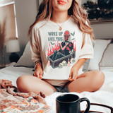 Woke Up Like This DTF Transfer, humorous graphic design featuring a devilish figure reading a book with flames, skulls, and bats, on a white T-shirt.