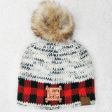 I Am Freaking Jolly TAN Leather Patch, knitted winter hat with a fluffy faux fur pom-pom on top, featuring a colorful red, black, and white tartan pattern design.