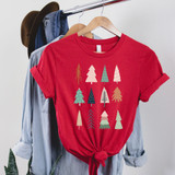 Boho Trees Screen Print Heat Transfer, festive Christmas-themed red T-shirt with colorful abstract tree designs tied at the waist.