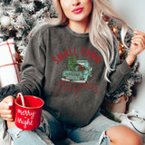Small Town Christmas DTF Transfer, Christmas-themed graphic on a sweatshirt showing an old truck with a Christmas tree and presents in the bed, with festive font.