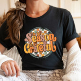 Tis The Season To Be Grateful DTF Transfer, seasonal Thanksgiving themed graphic T-shirt design with text and autumn plaid background.