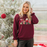 Holiday Spirits DTF Transfer, a Christmas-themed design of festive drinks and holiday elements printed on a maroon sweatshirt.
