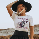 Beth Dutton Day Spa Screen Print Heat Transfer, fashion woman wearing graphic t-shirt and wide-brim hat in outdoor setting.