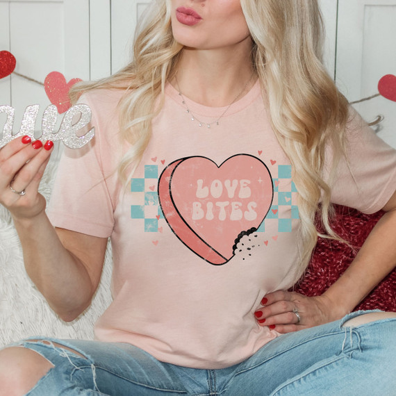 Love Bites Screen Print Heat Transfer, pink heart with the text 'Love Bites' on a woman's pink t-shirt.