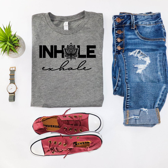 Inhale Exhale DTF Heat Transfer, gray t-shirt with black and cursive print design, showcasing a lotus flower and motivational words, paired with distressed blue jeans, red Converse sneakers, a wristwatch, and a small potted plant on white background.