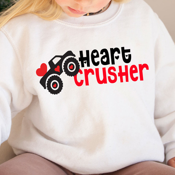 Heart Crusher DTF Heat Transfer, showing a girl wearing a white sweatshirt with a colorful graphic design featuring a tractor and hearts.