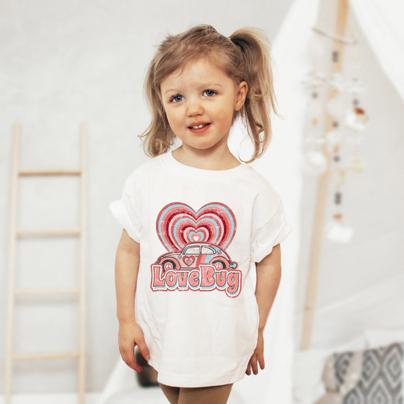 Love Bug DTF Heat Transfer, a girl wearing a white T-shirt with colorful heart and car design and the words Love Bug.