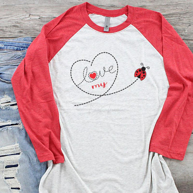 Love My Bug DTF Heat Transfer, image showing a baseball-style shirt with red sleeves and a white body featuring a love-themed design with a heart, the word 'love,' and a ladybug.