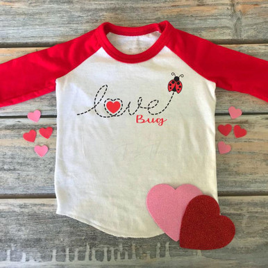 Love Bug Ladybug DTF Heat Transfer, heart and ladybug design on a white and red long sleeve shirt with pink and red felt hearts around.