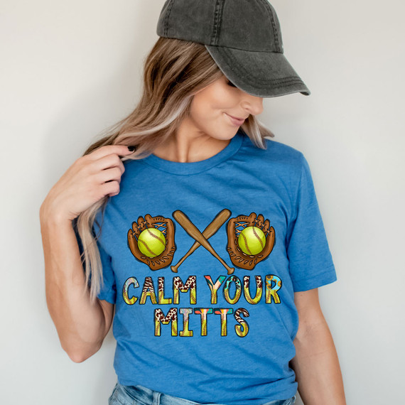 Calm Your Mitts Softball DTF Heat Transfer, colorful baseball-themed design on a woman's blue T-shirt.