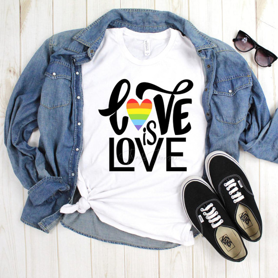 Love is Love Rainbow Heart Pride Text Sublimation Transfer, a white T-shirt with a rainbow-colored heart in the center and the words 'Love is Love' printed around it.