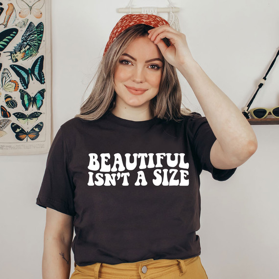 Beautiful Isn't A Size WHITE DTF Heat Transfer, a woman wearing a black t-shirt with this text and a red headscarf.
