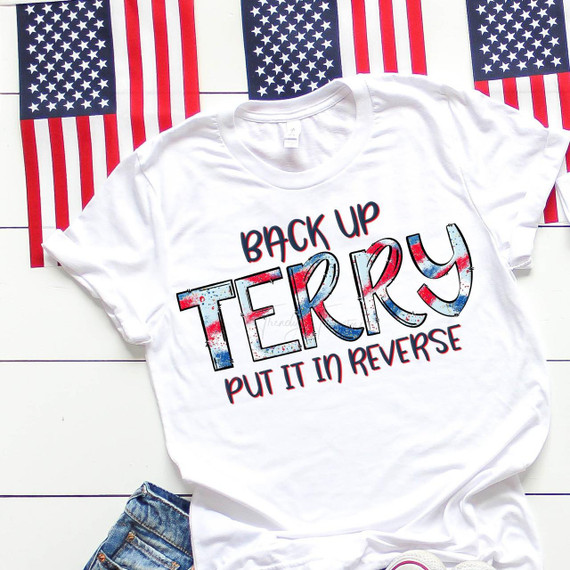 Back Up Terry Funny Patriotic Sublimation Transfer, white T-shirt with festive American flag-themed text and graphics, laid out on a patriotic background of American flags.