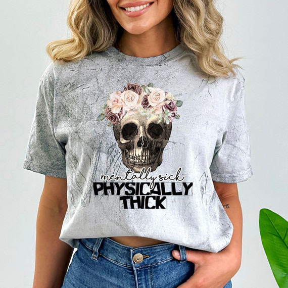 Mentally Sick Physically Thick DTF Heat Transfer, a stylish graphic t-shirt featuring a skull with a floral crown design and bold text.