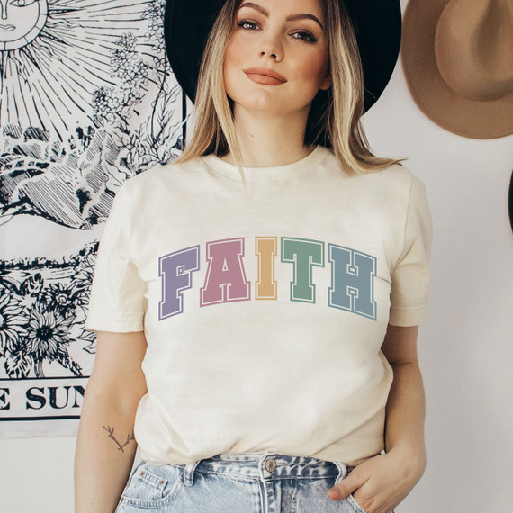 Faith Varsity Letters Screen Print Transfer, a multicolored varsity letter print on a woman's cream t-shirt.
