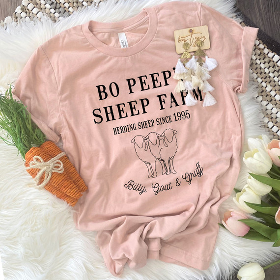 Bo Peep's Sheep Farm DTF Heat Transfer, pink T-shirt with black graphic and text design, featuring a line drawing of sheep and the words 'Herding Sheep Since 1995' and 'Billy, Goat & Gruff'.