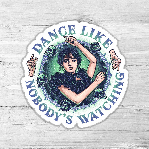 Dance Like Nobody's Watching Die Cut Sticker, humorous dance attitude sticker featuring a woman with short black hair, surrounded by barbed wire and skulls, on a white wooden background.