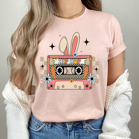Hip Hop Easter Mix Tape DTF Heat Transfer, colorful graphic design of a bunny ears headband, cassette tape with carrots and flowers on a pink background.