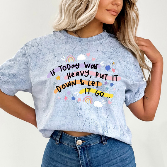 If Today Was Heavy, Put It Down & Let It Go DTF Heat Transfer, colorful design with rainbows, clouds, hearts, and stars on a light blue distressed T-shirt.